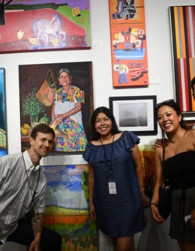 Photo of four artists including Norma Martinez, NormaNahuaArt, posing in front of their paintings