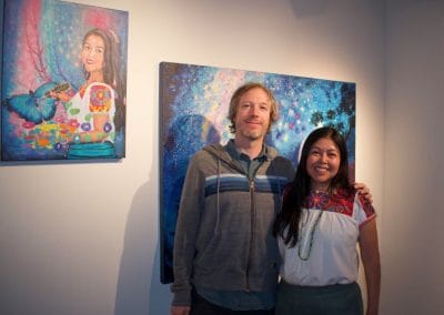 Two artists posing with artwork.