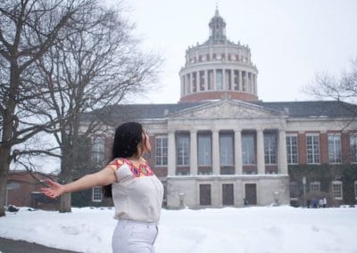 Woman in snow, historic building backdrop
